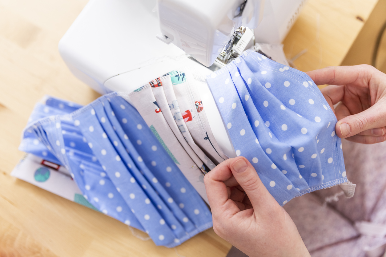 Woman's hands sewing face masks