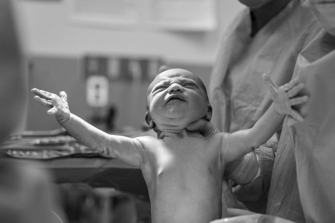 Cute baby being born